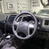 Toyota HiLux 7th Gen (2005–2015) Steering Wheel Wrap – Black Leather (smooth top, perforated sides), Black stitch