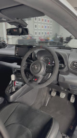 Toyota GR Yaris (2020-2025) Steering Wheel Wrap – Black Alcantara, Black stitch, Red Holo-stripe marker